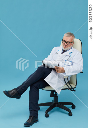 Doctor writing a treatment Doctor writing a treatment 60383320