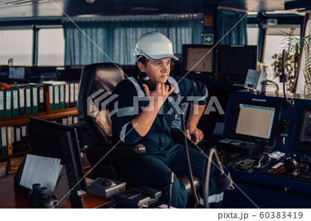 Marine navigational officer during navigational watch on Bridge . Work at sea 60383419