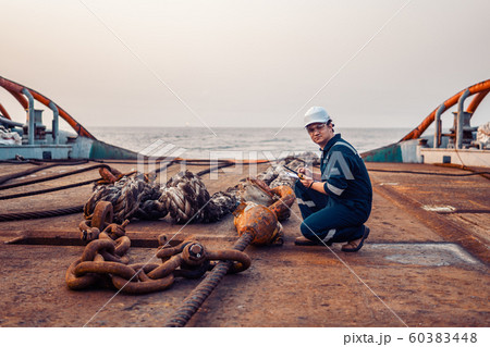 Marine chief officer or chief mate on deck of ship or vessel. He fills up ahts vessel checklist Marine chief officer or chief mate on deck of ship or vessel. He fills up ahts vessel checklist 60383448