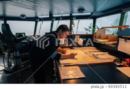 Marine navigational officer during navigational watch on Bridge Marine navigational officer during navigational watch on Bridge 60383511