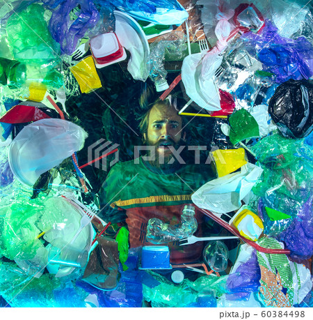 Man drowning in ocean water under plastic recipients pile, environment concept Man drowning in ocean water under plastic recipients pile, environment concept 60384498