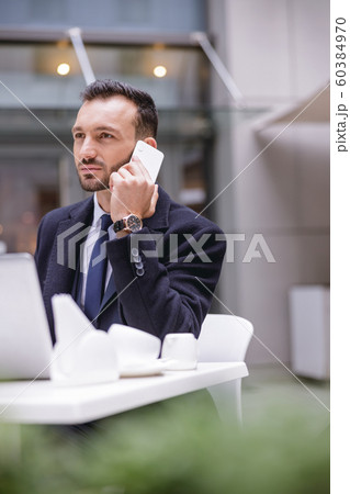Concentrated bearded businessman listening to his interlocutor Concentrated bearded businessman listening to his interlocutor 60384970
