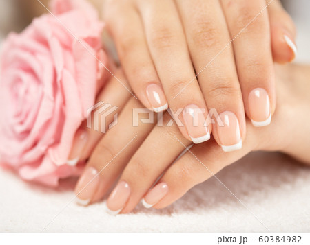 Woman gets manicure procedure in a spa salon. Woman gets manicure procedure in a spa salon. 60384982