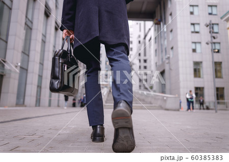 Low angle photo of man that going to his work 60385383