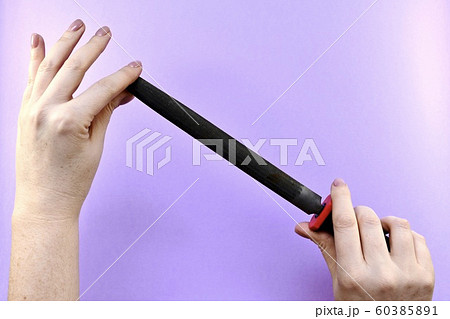 Demonstration of the tool file with two women's hands. 60385891