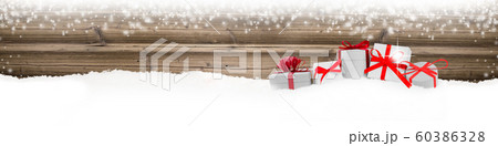 Gifts with Red Ribbons and Bag on Wooden Gifts with Red Ribbons and Bag on Wooden 60386328