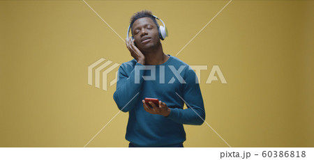 Young man enjoying music Young man enjoying music 60386818