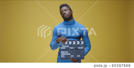 Bored man using film clap Bored man using film clap 60387666