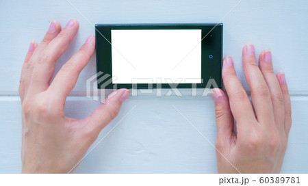 Woman using smartphone with white empty display 60389781