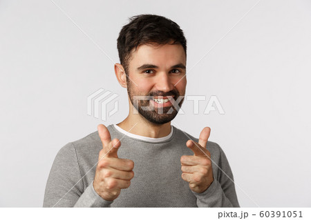 Gotcha. Cheeky, enthusiastic, handsome bearded caucasian male in grey sweater, pointing camera finger pistols and smiling joyfully, congratulate friend, praise achievement, standing white background Gotcha. Cheeky, enthusiastic, handsome bearded caucasian male in grey sweater, pointing camera finger pistols and smiling joyfully, congratulate friend, praise achievement, standing white background 60391051