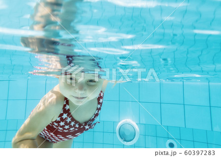 Funny child dive underwater in swimming pool Funny child dive underwater in swimming pool 60397283