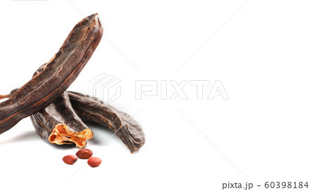 Carob carob fruit and seeds on white background. 60398184