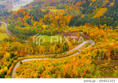 Picturesque autumn landscape with road between the hills. Czech Republic 60402103
