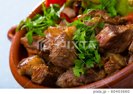 Cooked gyuvech dish of bulgarian cuisine of beef with vegetables at clay pot Cooked gyuvech dish of bulgarian cuisine of beef with vegetables at clay pot 60403660