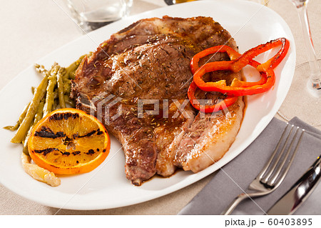 Entrecote with asparagus and orange 60403895