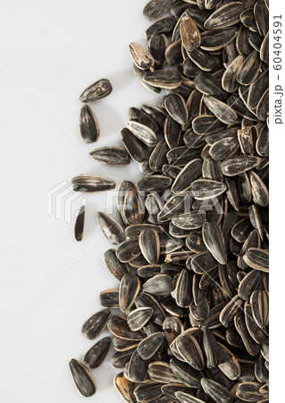Sunflower seeds on a white surface Sunflower seeds on a white surface 60404591