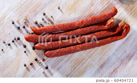 Appetizing smoked sausages for snacks Appetizing smoked sausages for snacks 60404721