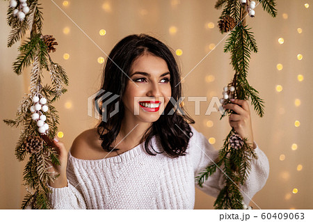 beautiful woman on swing with Christmas decorations 60409063
