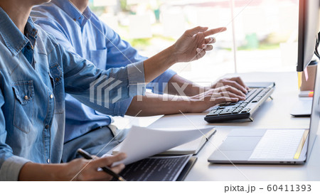 Pensive programmer working on on desktop pc 60411393