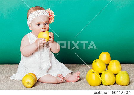 baby girl in a dress with Green apples baby girl in a dress with Green apples 60412284