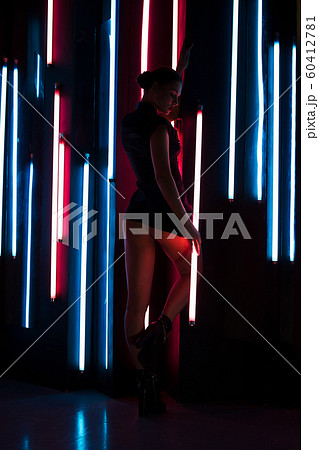 Slim woman with neon lamp 60412781
