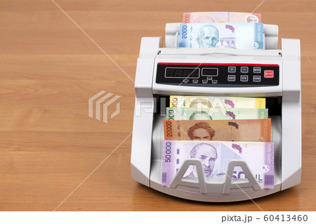 Costa Rican money in a counting machine 60413460