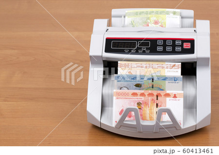 French Pacific Territories money in a counting machine French Pacific Territories money in a counting machine 60413461