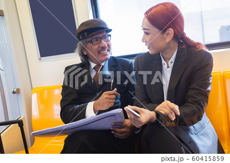 asian senior businessman and young businesswoman talking on the way go to work 60415859