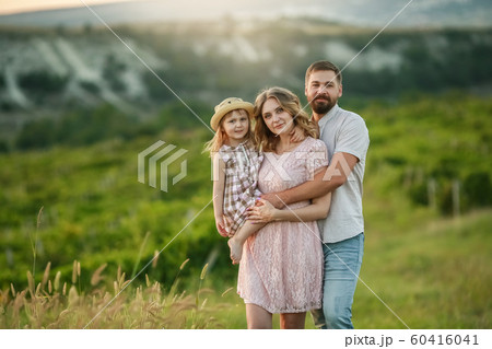 Happy family: mother father and child daughter on nature on sunset 60416041