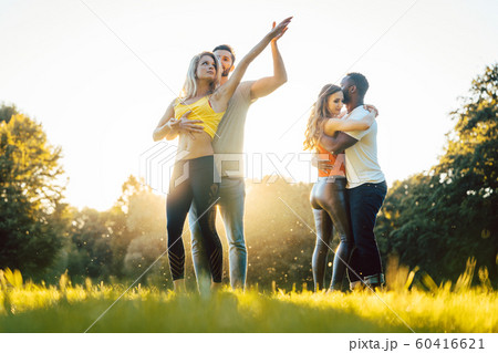 Group of people dancing Kizomba in sunset 60416621