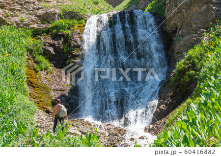 A man stands on the background of a waterfall 60416882