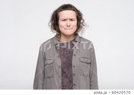 Young caucasian female student feeling guilt for mistake in term paper Young caucasian female student feeling guilt for mistake in term paper 60420570