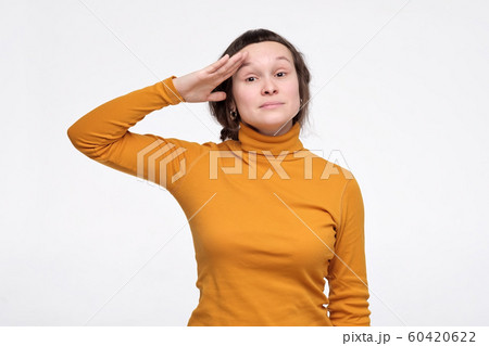 Caucasian young woman in yellow clothes is ready to do her best at work. 60420622