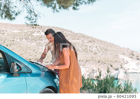 Young couple tourist with map travelling by car Young couple tourist with map travelling by car 60421095