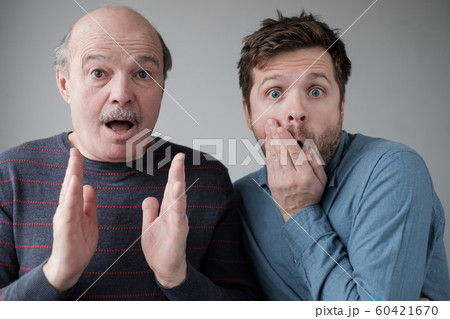 Frightened two men have scared expressions, look nervously, Frightened two men have scared expressions, look nervously, 60421670