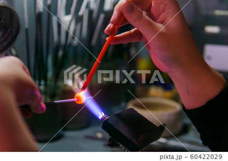 hand-made glass beadmaking in a glass-blowing 60422029