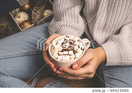 Hot sweet cocoa christmas drink in female hands. 60423080