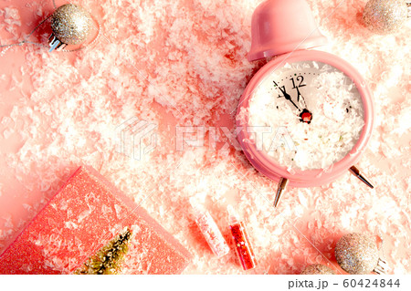 Pastel pink alarm clock at five minutes to midnight  60424844