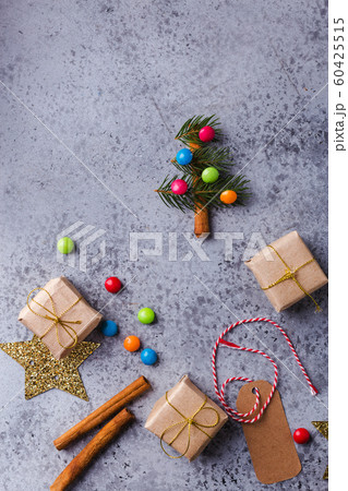Christmas background with mini Christmas tree, gift boxes, festive decor, fir tree, candies Christmas background with mini Christmas tree, gift boxes, festive decor, fir tree, candies 60425515