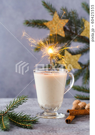 Christmas background with, gift boxes, stars, festive decor, fir tree, cinnamon sticks, hot eggnog Christmas background with, gift boxes, stars, festive decor, fir tree, cinnamon sticks, hot eggnog 60425555