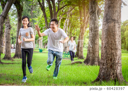 Happy family,asian little child girl or daughter playing tag game,running joyful with father and mother in summer green nature,dad,mom having fun,play touch and laughing in outdoor park enjoy Happy family,asian little child girl or daughter playing tag game,running joyful with father and mother in summer green nature,dad,mom having fun,play touch and laughing in outdoor park enjoy 60428397
