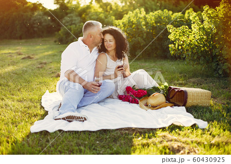Beautiful adult couple spend time in a summer field 60430925