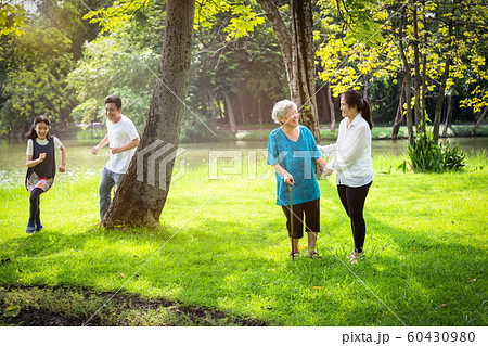 Happy family,asian little child girl or daughter playing touch,tag game,fun,running with father,senior grandmother and mother having smile,laugh in outdoor park,parents enjoy,summer vacation concept Happy family,asian little child girl or daughter playing touch,tag game,fun,running with father,senior grandmother and mother having smile,laugh in outdoor park,parents enjoy,summer vacation concept 60430980