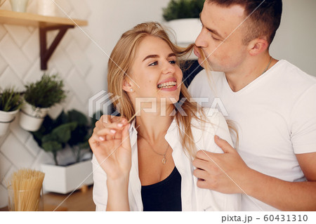 Beautiful couple spend time in a kitchen 60431310