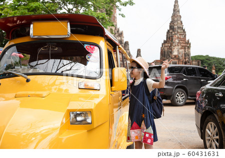 Asian tourist girl query for the way with old man driver taxi or tuk tuk touring,parking lot in front of Wat Chaiwatthanaram at Ayutthaya,Thailand 60431631