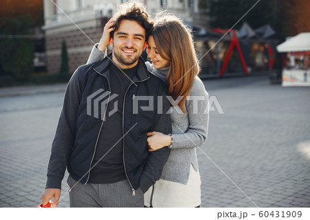 Beautiful couple spend time in a summer city Beautiful couple spend time in a summer city 60431909