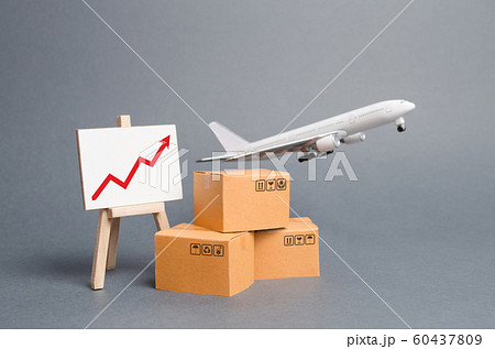 Airplane plane takes off behind stack of cardboard boxes and stand with red up arrow. concept of air cargo and parcels, airmail. Fast delivery of goods and products. Cargo aircraft. Logistics, 60437809
