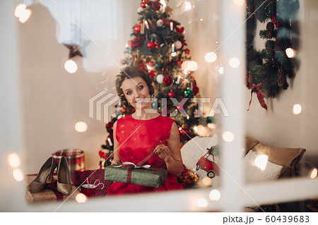 Pretty smiling woman sitting in her bedroom with Pretty smiling woman sitting in her bedroom with 60439683