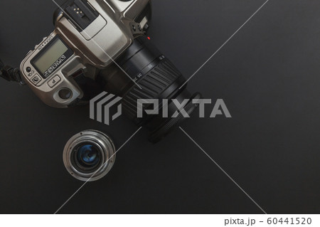 Photographer workplace with dslr camera system and lens on dark black table background. Hobby travel photography concept. Flat lay top view copy space. 60441520