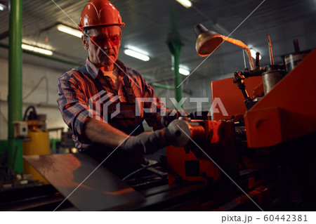 Man making the metal on lathe 60442381